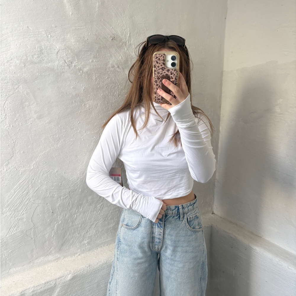 white Nike Dri-FIT One Luxe
Women's Long-Sleeve Cropped Top - Picture 10 of 12